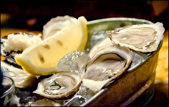 A bar patronized for drinks and bivalve oysters