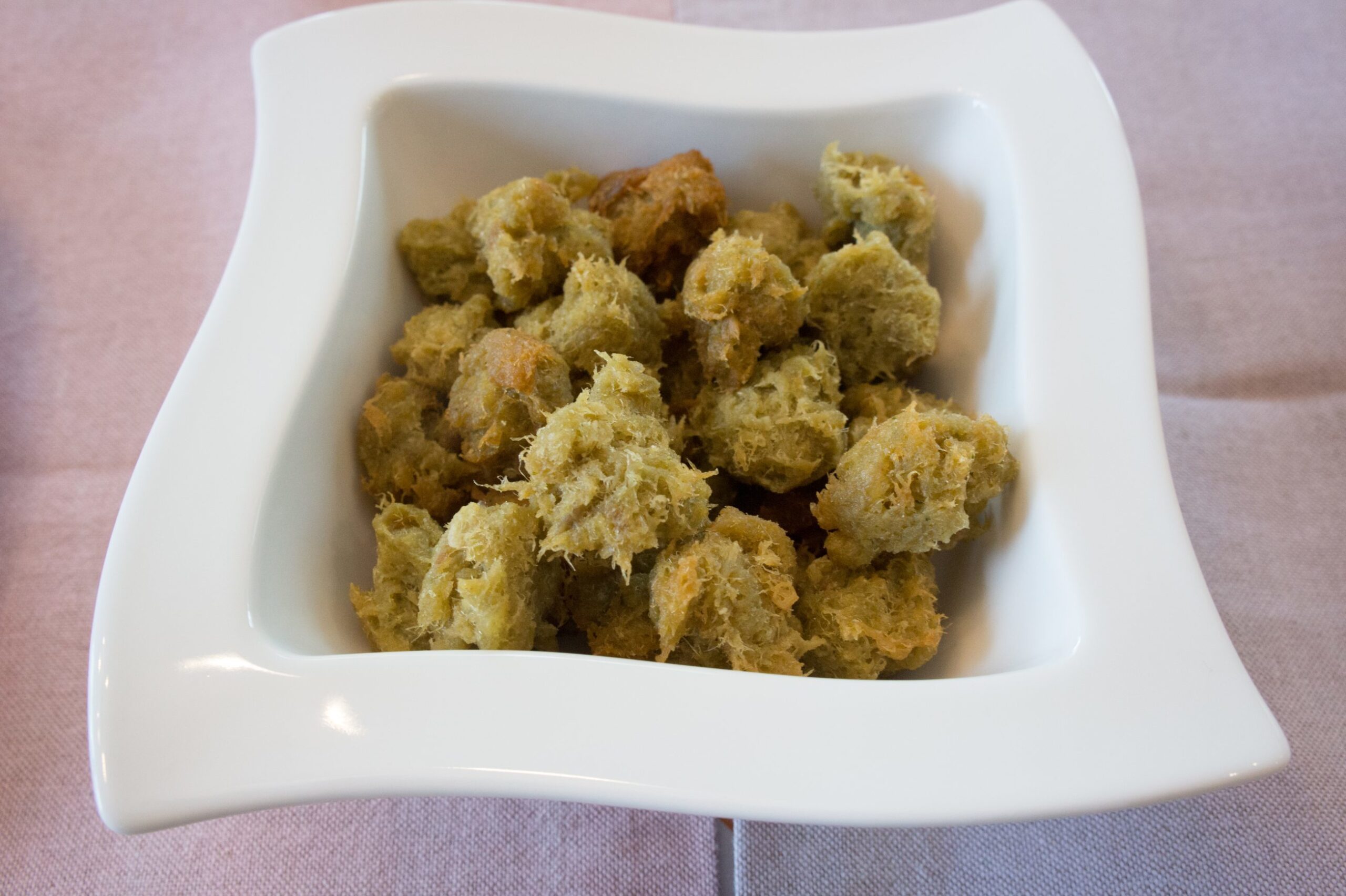 A prepared plate of fried cod fritters