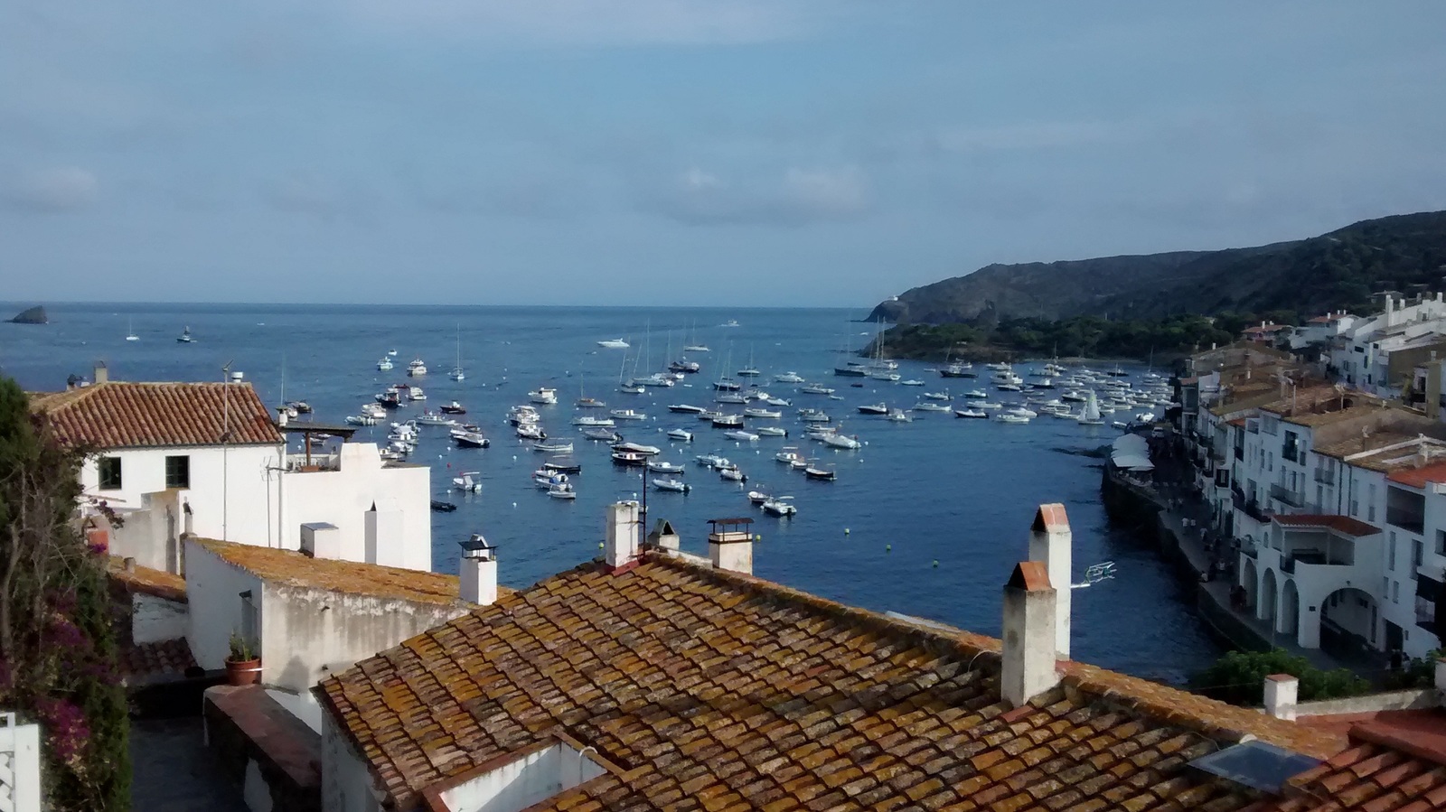 Vehicles parked by a dock on the sea coast of Costa Brava
