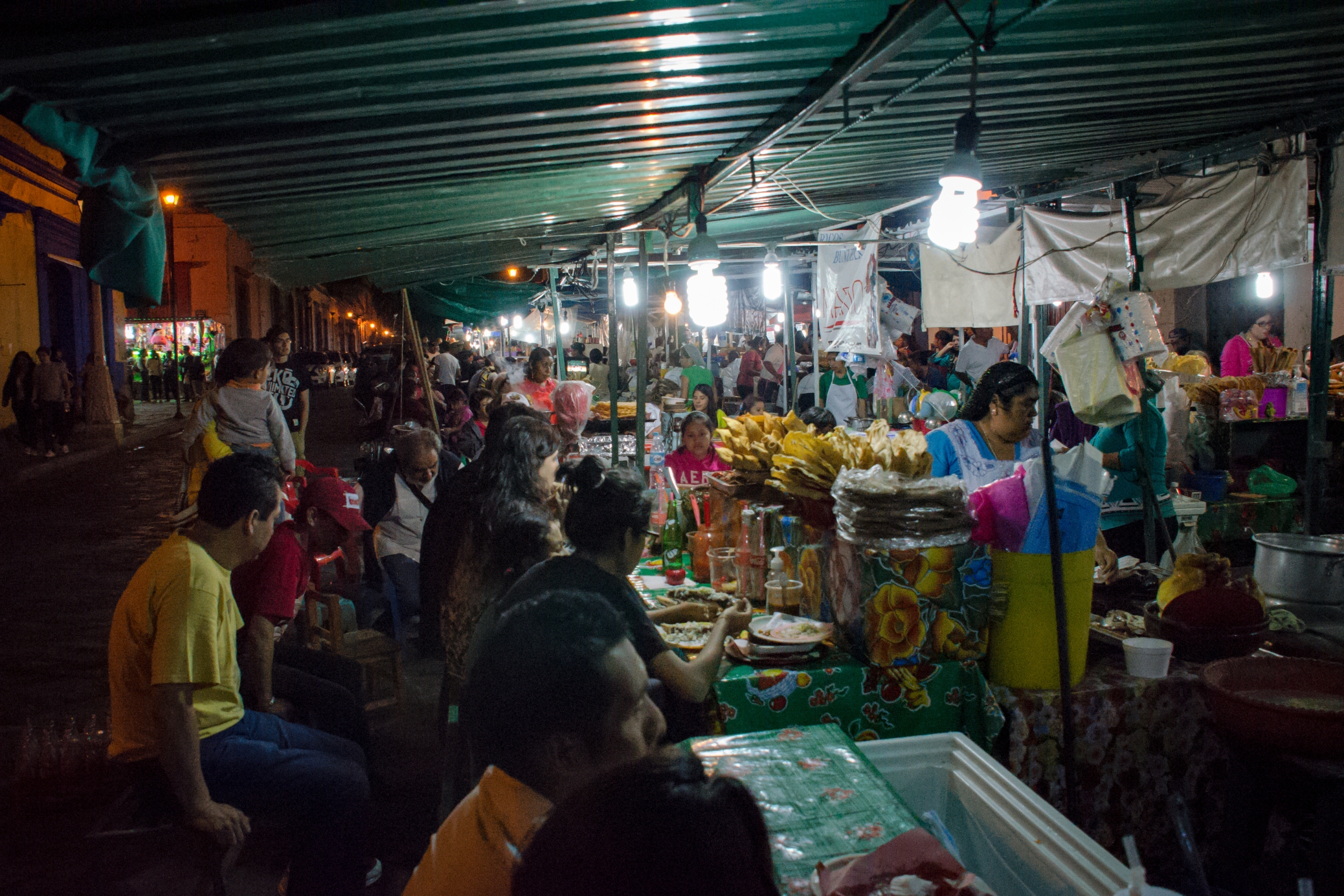 A vendor serving street food in Oaxaca