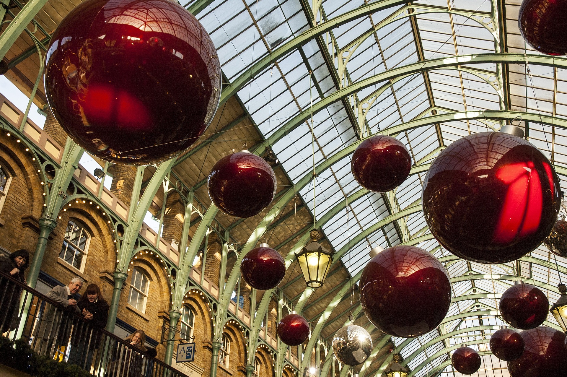 Boules colorées et guirlandes scintillantes accrochées aux branches d'un sapin.