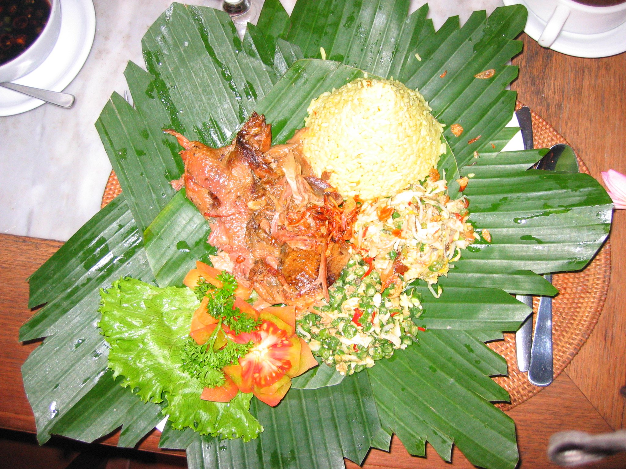 Andrew Zimmern Bizarre Foods Delicious Destinations Bali - Roasted duck with vegetable salad, vegetable side dishes and rice