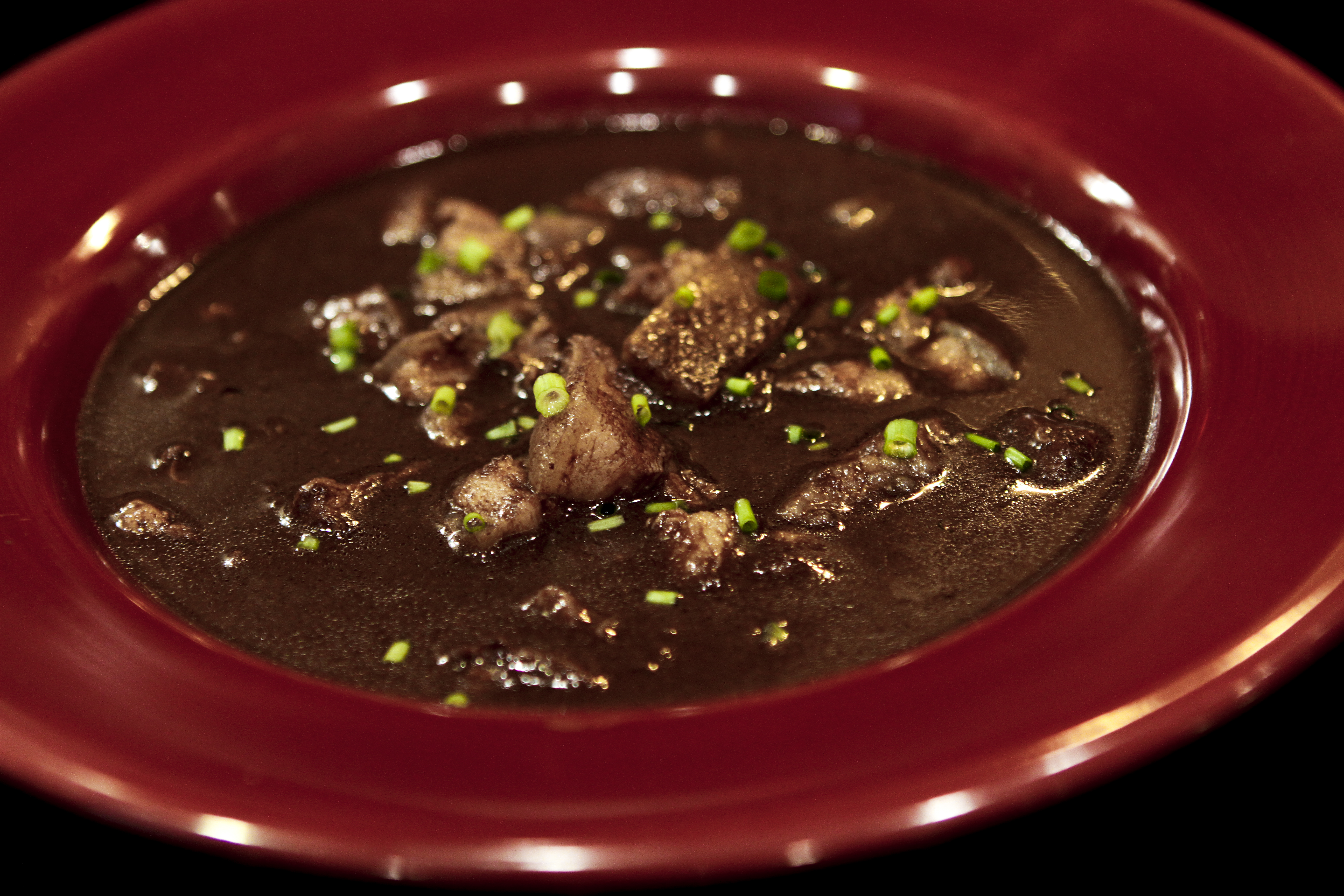 Andrew Zimmern Delicious Destinations Manila - Pig innards with pig's blood sauce