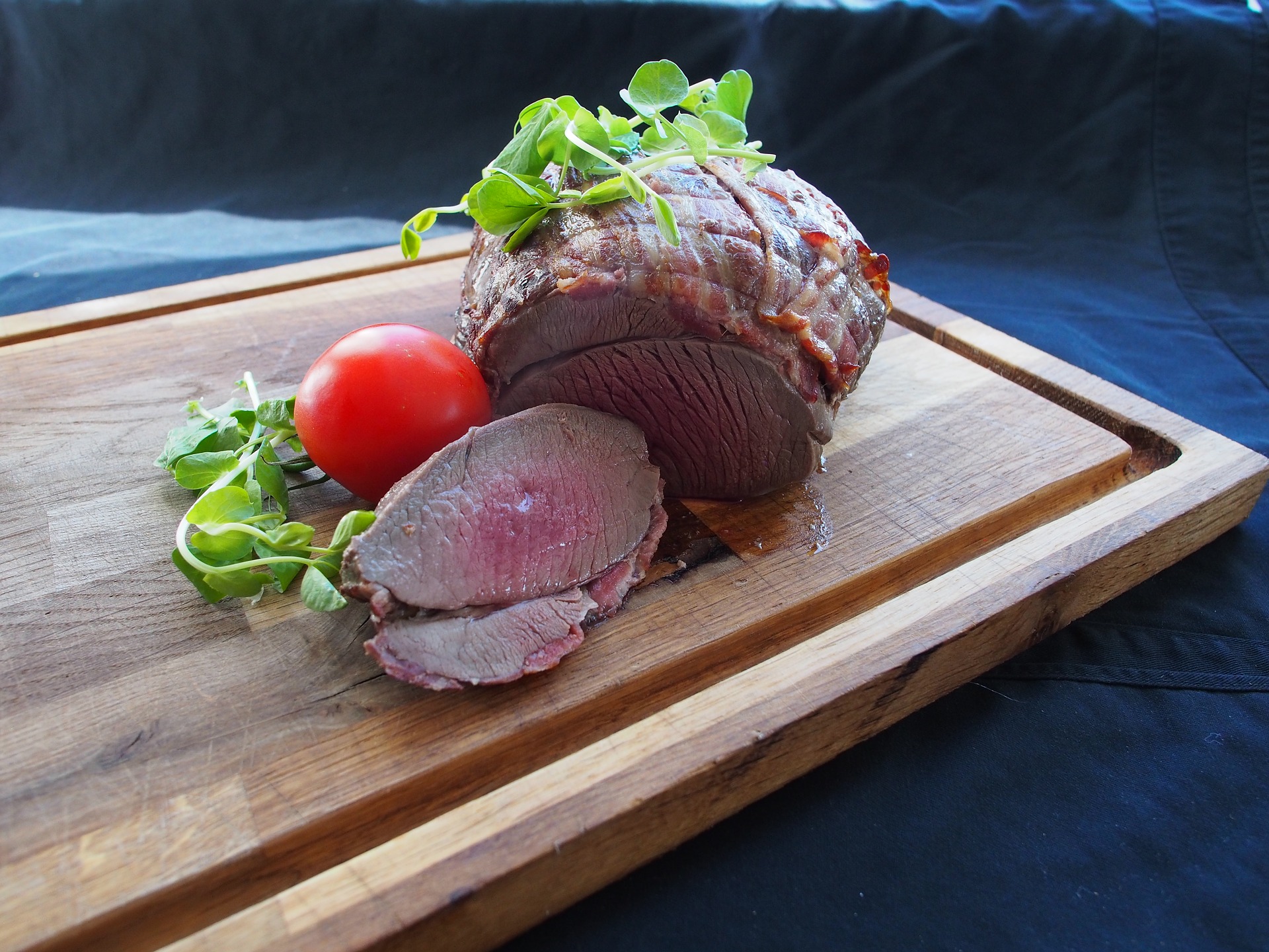 Delicious destinations Quebec City-A slice of red deer meat garnished with lettuce and cherry tomato