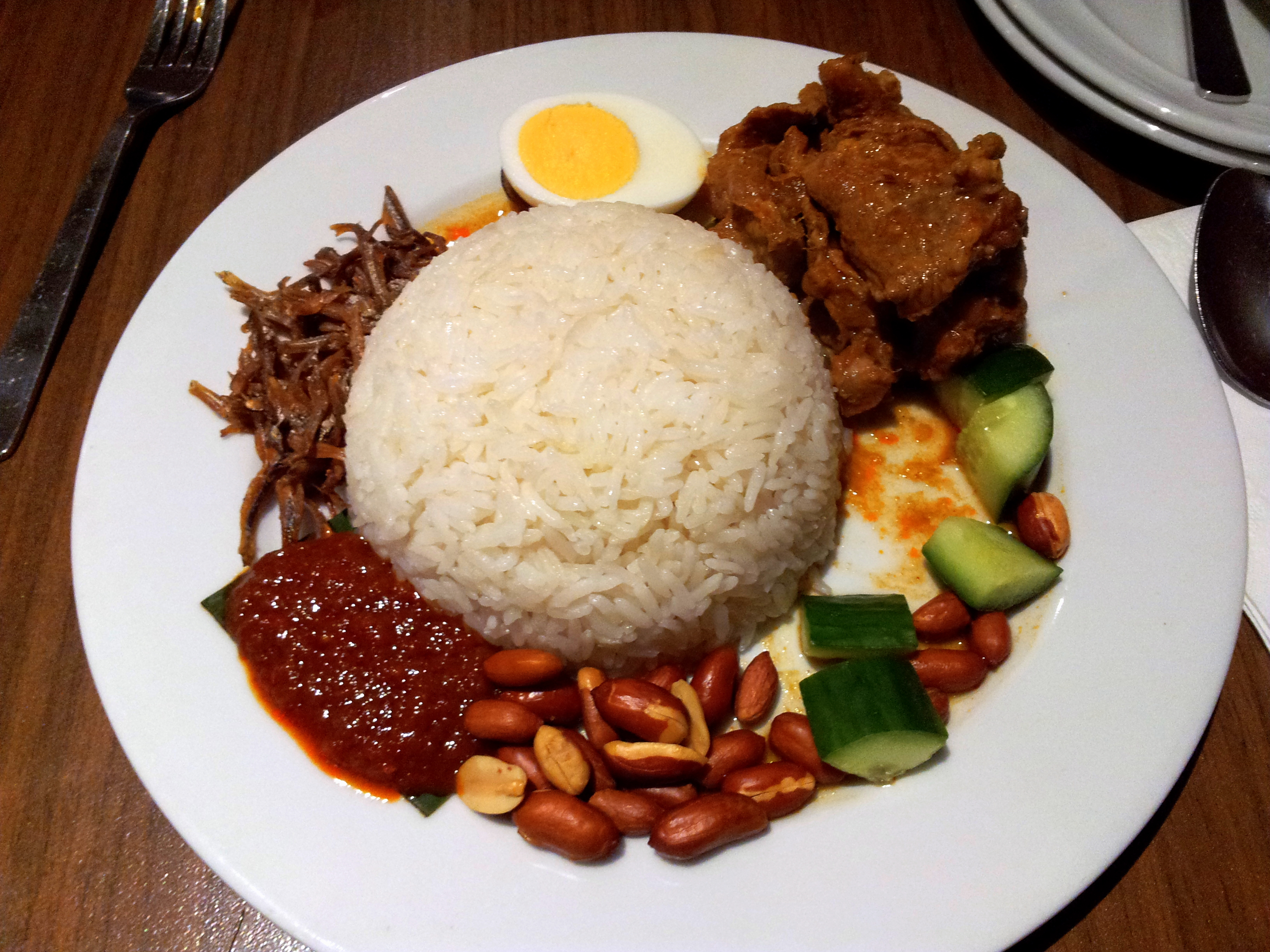 Basmati rice with side dish of chili sauce, cucumber, nuts, chicken, egg and dried fish