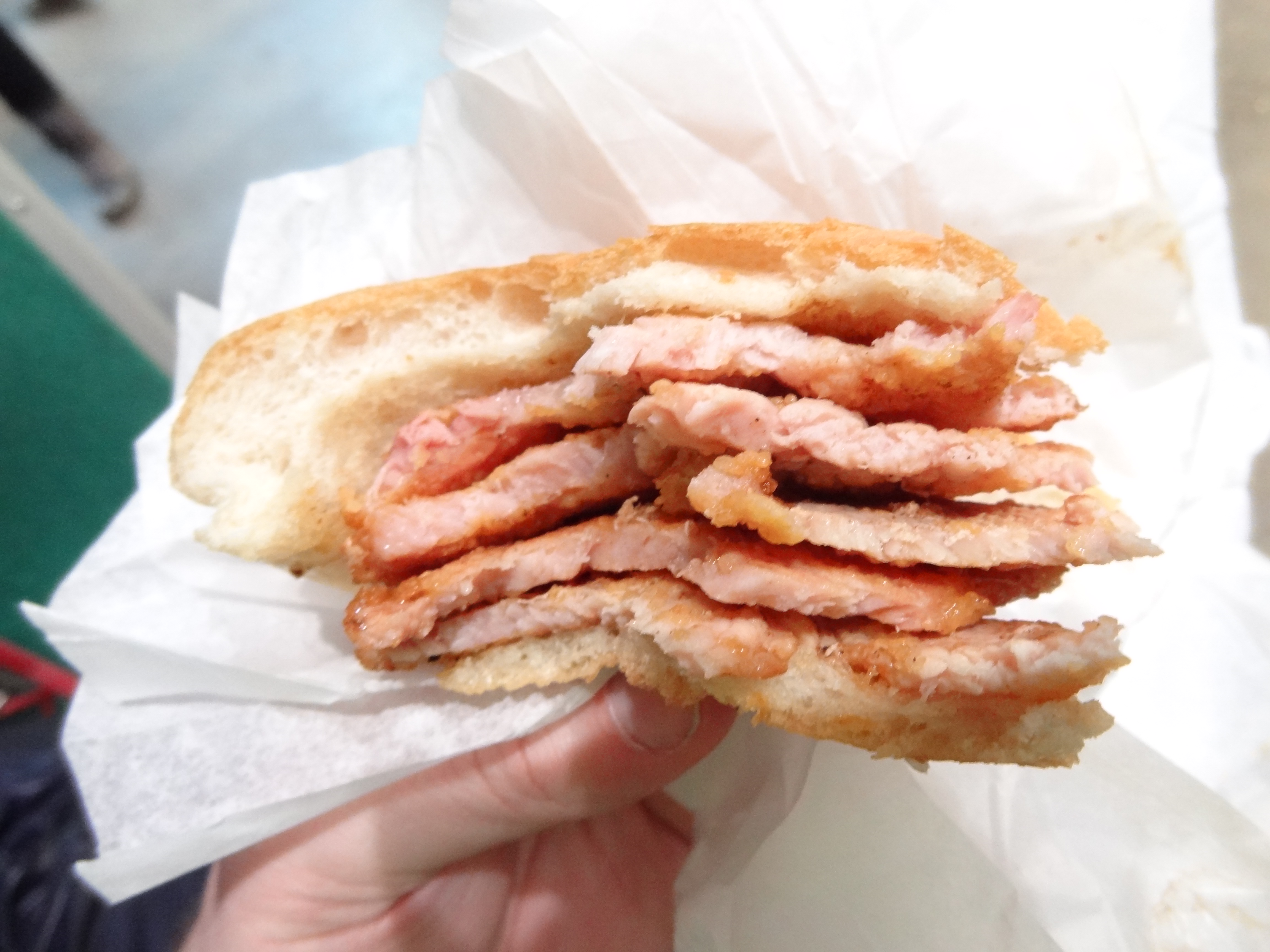 ANDREW ZIMMERN BIZARRE FOODS DELICIOUS DESTINATIONS TORONTO - Thin slices of cornmeal bacon in a bun