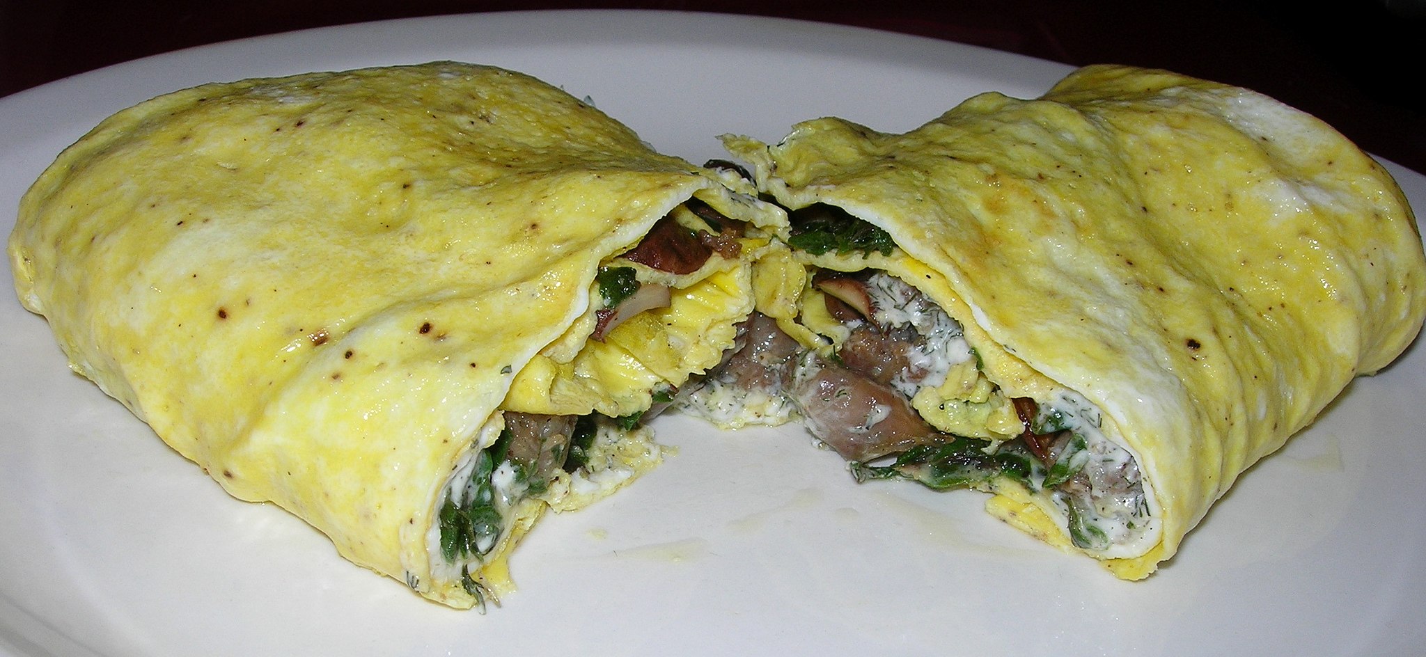 Mix of chicke meat, sliced vegetables with herbs and spices wrapped in Roti bread