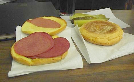 Andrew Zimmern Bizarre Foods Delicious Destinations Montreal - A sandwich with mustard, salami, bologna and pickles