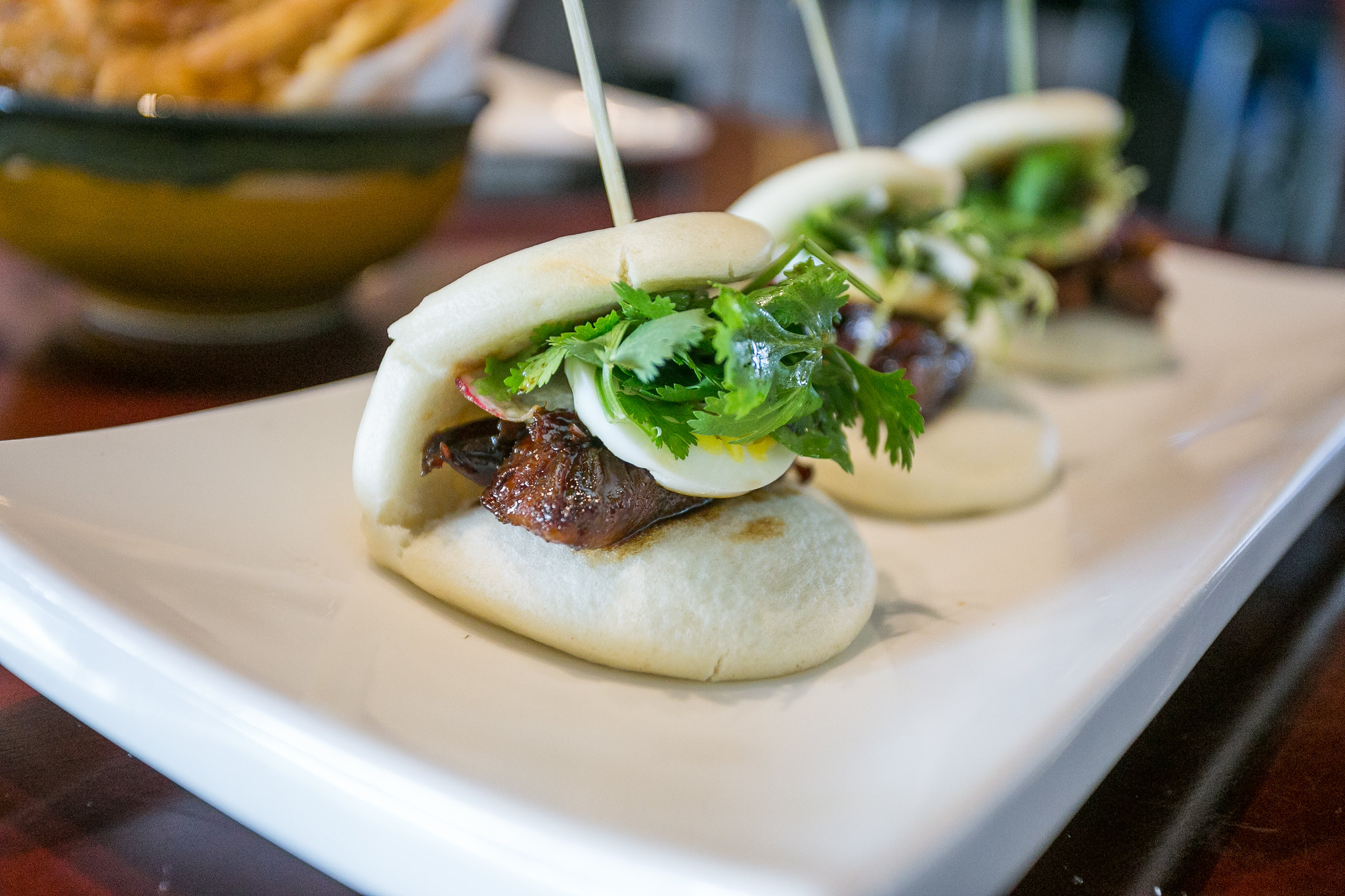Pork Belly Steamed Buns, an example of Asian Fusion Sticky Buns - photo by City Foodsters under CC BY 2.0