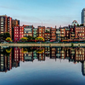 Brownstones of Boston's Back bay neighborhood reflected in the Charles River - photo by Robbie Shade under CC BY 2.0