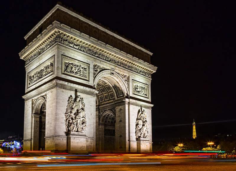historical sites in Paris - Arc de Triomphe at night - photo by Sheila Sund under CC BY 2.0
