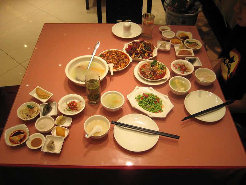 Anthony Bourdain Sichuan - Sichuan dinner with an array of appetizers, soup and main dishes - photo by rduta under CC BY 2.0