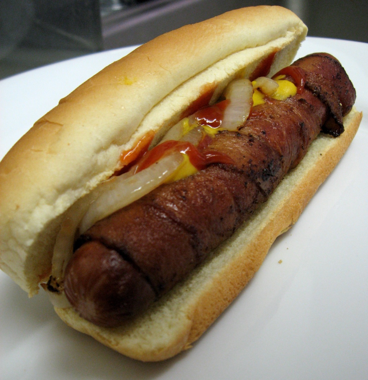 Bacon-wrapped Hot Dog - photo by Arnold Gatilao under CC BY 2.0